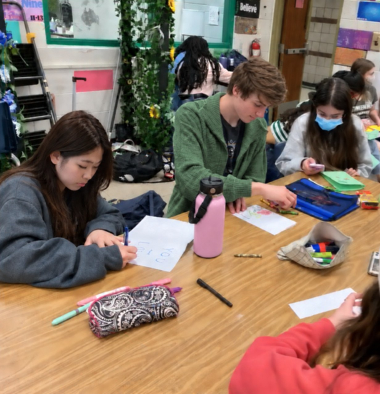 Students drawing and writing cards