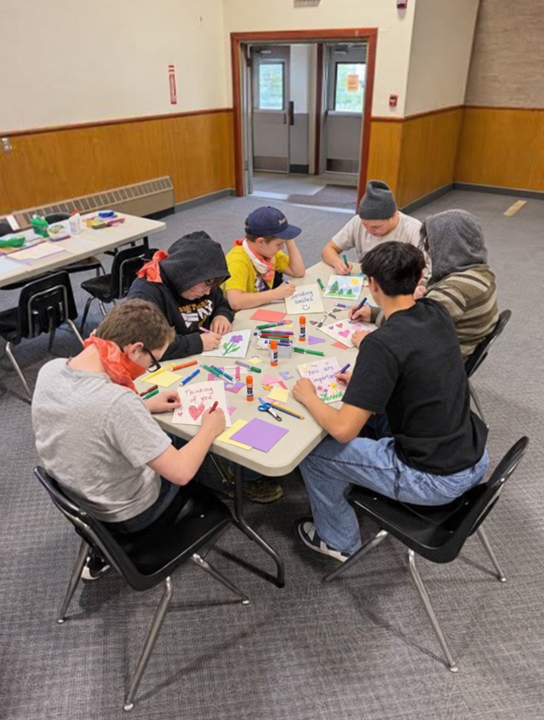 A group making cards around a classroom table