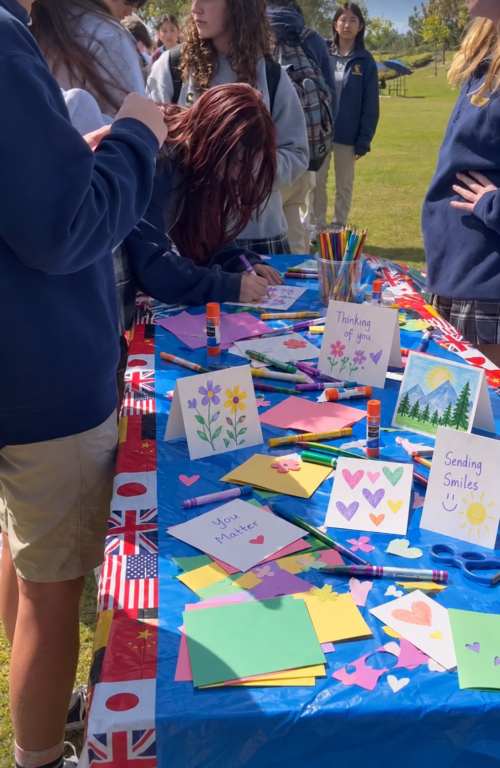 An outdoor table filled with handmade cards